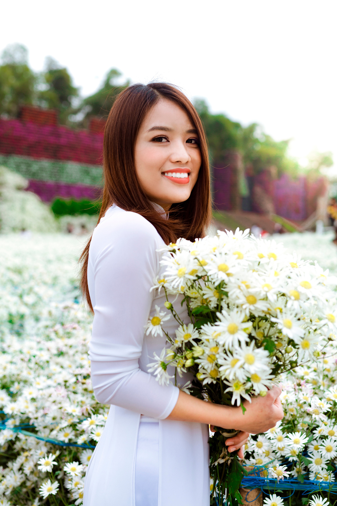 Delighted Asian female in blooming garden